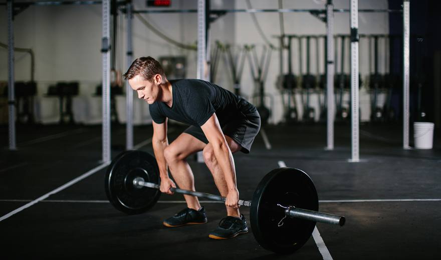 Man lifting a barbell from the floor